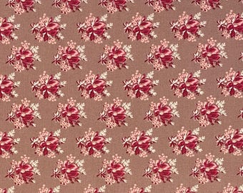 May include: A brown fabric with a repeating pattern of pink and white floral bouquets.