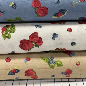 May include: Three fabric swatches with a repeating pattern of red strawberries, green leaves, and blue and black berries on a white, beige, and blue background.