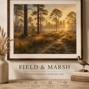 May include: A framed landscape print featuring a sunlit pine forest at dawn with a dirt path winding through tall golden grasses. Below the image, the text reads FIELD & MARSH, VINTAGE INSPIRED SPORTING ART, and BRING THE QUIET BEAUTY OF THE OUTDOORS INTO YOUR HOME.