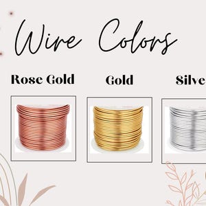 May include: Image showcasing three spools of wire in Rose Gold, Gold, and Silver. The text "Wire Colors" is displayed above the spools. The image is set against a neutral background with decorative floral elements.
