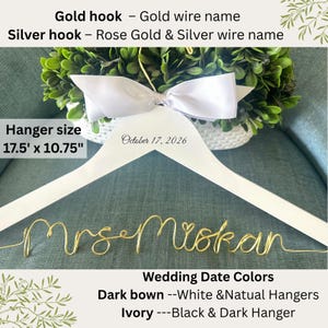 May include: A white wooden hanger with a gold wire name, "Mrs Mrokan." The hanger has a white bow and the date "October 17, 2026." The hanger size is 17.5" x 10.75".