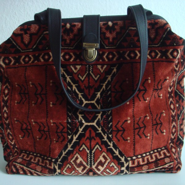 Brick colour velvet carpet bag with woven design in black and cream and black leather shoulder straps (66 cms)