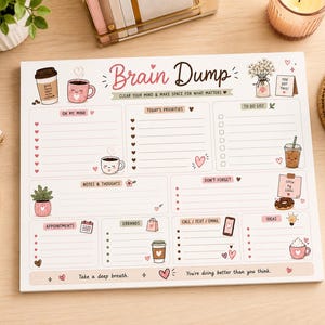 May include: A rectangular paper notepad titled Brain Dump with sections for priorities, to-do lists, notes, and appointments. The white page features pink and brown illustrations of coffee cups, plants, and hearts, with text including Clear your mind and make space for what matters and Take a deep breath. You're doing better than you think.