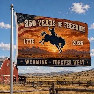 以下が含まれることがあります： アメリカ国旗のデザインと「250 YEARS OF FREEDOM」と「WYOMING - FOREVER WEST」の文字が入った旗。夕焼けを背景に、馬に乗ったカウボーイのシルエットが描かれています。1776年と2026年の文字も含まれています。