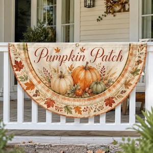 May include: A semi-circular fabric banner featuring the text Pumpkin Patch in brown script. The design includes illustrations of three pumpkins in orange, white, and green, surrounded by autumn leaves, wheat stalks, and acorns on a cream background.