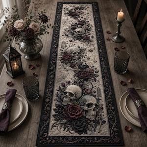 May include: A rectangular table runner featuring a repeating pattern of human skulls, dark red and black roses, and intricate vine motifs on a beige background, framed by a wide black border with ornate, decorative scrollwork and floral details.