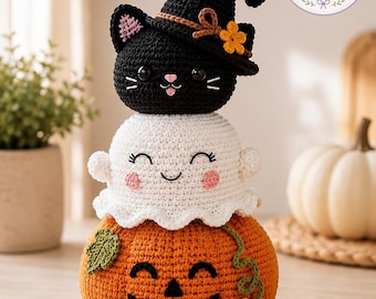 May include: A stacked crochet decoration featuring an orange jack-o'-lantern base, a white ghost in the middle, and a black cat wearing a witch hat on top. The top right corner displays a circular logo with the text Charm Loop Crochet.