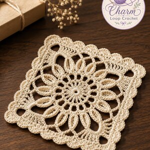 May include: A square, cream-coloured crochet doily featuring a central circular floral motif with radiating petals and a scalloped edge. The design includes intricate openwork patterns and a delicate, textured stitch throughout the piece.