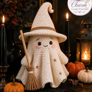 May include: A cream-colored crocheted ghost figurine wearing a pointed hat with a brown band, featuring embroidered eyes, a small smile, pink cheeks, and gold star accents. The ghost holds a small brown broomstick, with the text Charm Loop Crochet.