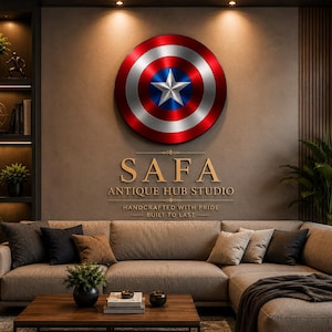 May include: A circular wall-mounted shield featuring a metallic red, white, and blue design with a central white star. Below the shield, gold text reads SAFA ANTIQUE HUB STUDIO, HANDCRAFTED WITH PRIDE, BUILT TO LAST, displayed on a neutral wall.