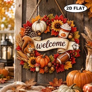 May include: A circular autumn wreath featuring a squirrel, pumpkins, sunflowers, a football, a coffee cup, and red berries. A central banner displays the text "welcome" in cursive script. The wreath is decorated with fall foliage and includes a "2D FLAT" label.