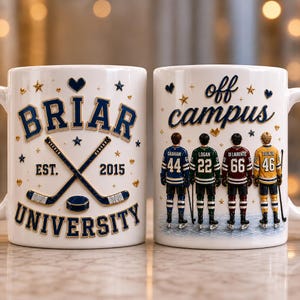 May include: Two white ceramic mugs featuring hockey-themed graphics. One mug displays the text BRIAR UNIVERSITY EST. 2015 with crossed hockey sticks and a puck. The other mug shows the text off campus above four hockey players in jerseys.