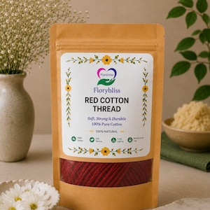 May include: A tan stand-up pouch containing red cotton thread. The label features the text Florybliss RED COTTON THREAD, Soft, Strong & Durable, 100% Pure Cotton, 100% NATURAL, and icons for 100% Cotton, Soft Texture, Long Lasting, and Multipurpose Use.
