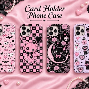 May include: Four phone cases with card holders, each featuring distinct patterns: pink with skulls, bats, and cherries; a pink and black checkerboard with a teddy bear; a black background with a cat on a moon; and a light purple with cats and ghosts.