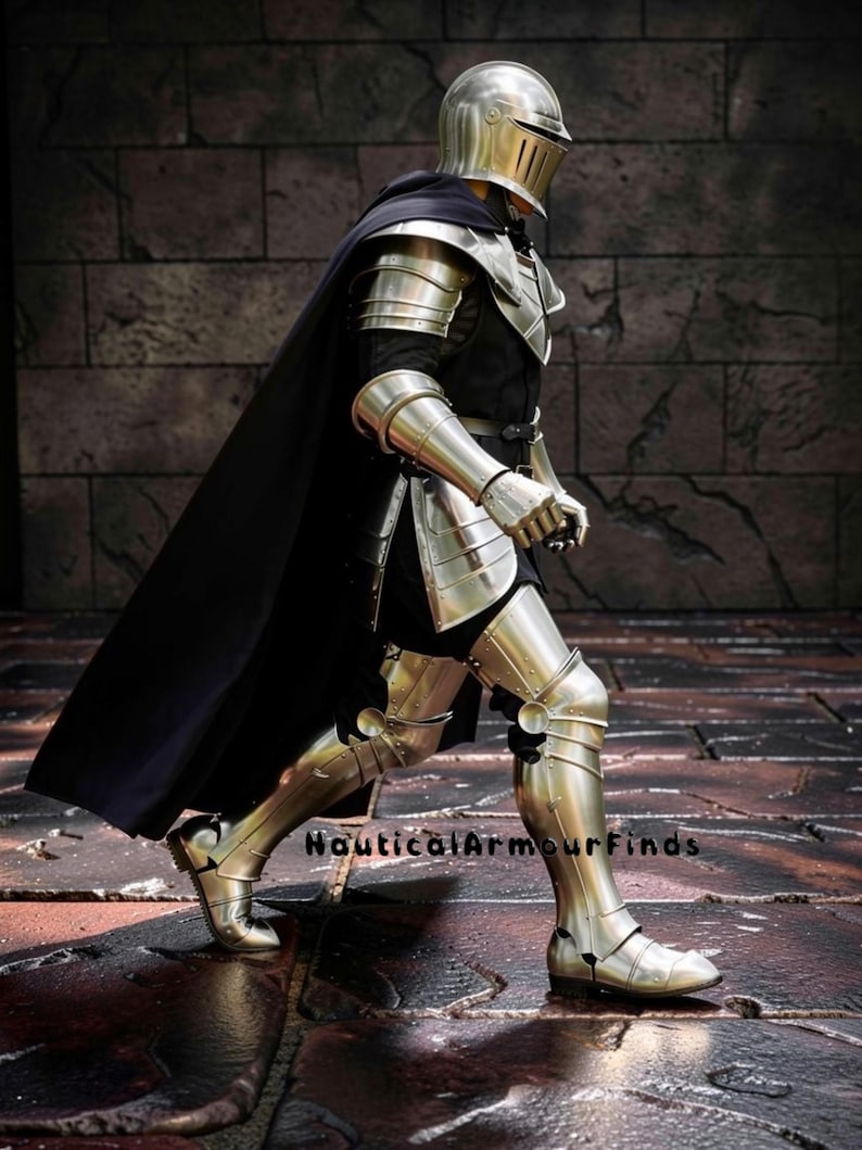 May include: A full suit of polished steel armor, including a helmet, shoulder guards, arm and leg protection, and boots. A black cape drapes over the shoulders. The text "Nautical Armour Finds" is visible.