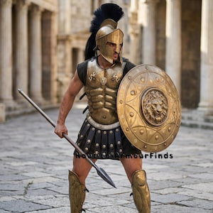 May include: A metallic gold Spartan-style helmet with a black crest, a matching breastplate featuring a central lion emblem, a round shield with a lion relief, and gold greaves. A long spear is held in hand. The text NauticalArmourFinds is visible.