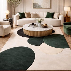 May include: A rectangular area rug featuring a cream-colored base with large, overlapping circular patterns in dark forest green and black. The rug has a plush, textured pile and is designed with a geometric arrangement of these solid-colored circles.
