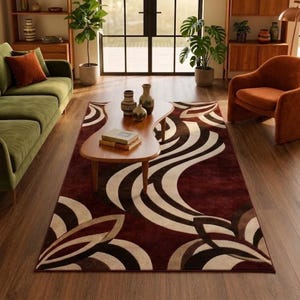 May include: A rectangular area rug featuring a large-scale abstract pattern with sweeping curved lines in deep burgundy, dark brown, and cream tones. The design creates a flowing, organic motif that covers the entire surface of the floor covering.