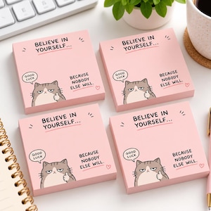 May include: Four square light pink sticky notes featuring a cartoon cat giving a thumbs up. The text reads: BELIEVE IN YOURSELF... BECAUSE NOBODY ELSE WILL. A small speech bubble says GOOD LUCK and a tiny heart is printed on the bottom right.