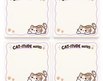 May include: Four square sticky note pads featuring a cream background with a wavy purple border. Each pad displays the text CAT-ITUDE NOTES in brown, accompanied by a small paw print and a brown and white tabby cat illustration.