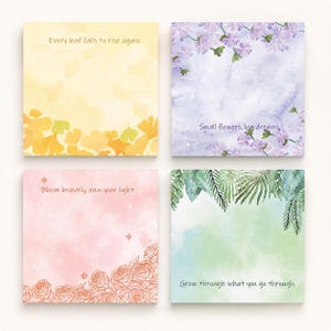 May include: Four square sticky note pads with watercolor backgrounds. Top left is yellow with ginkgo leaves and text Every leaf falls to rise again. Top right is purple with flowers and text Small flowers, big dreams. Bottom left is pink with roses and text Bloom bravely, own your light. Bottom right is green with leaves and text Grow through what you go through.