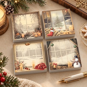 May include: A set of four square sticky note pads featuring winter holiday illustrations. Each pad displays a window view of a snowy landscape with festive elements like candles, a Christmas tree, a red stocking, a snowman, and bells.