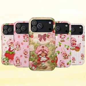 May include: Five smartphone cases featuring a character with a strawberry-patterned hat and dress. The designs include repeating strawberry motifs, a pink gingham background, and a central illustration of the character walking on a path.