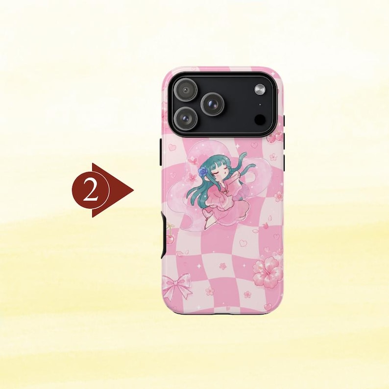 May include: A pink and white checkered phone case featuring a cartoon character with teal hair wearing a pink outfit, surrounded by small pink flowers, hearts, and a bow. A dark red arrow icon with the number 2 is positioned to the left of the case.
