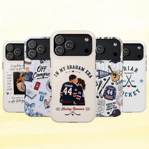 May include: Five white smartphone cases featuring various graphic designs. The center case displays a couple in hockey jerseys with the text 'IN MY GRAHAM ERA' and 'Hockey Romance'. Other cases show stickers, text, and hockey-themed illustrations.