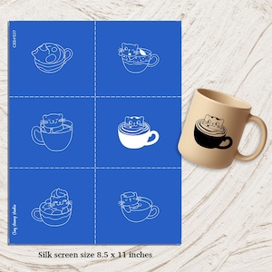 May include: A blue silk screen with cat-in-a-cup designs and a beige mug. The screen features six cat illustrations in cups, with the text "Silk screen size 8.5 x 11 inches". The mug has a black cat-in-a-cup design.