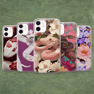 May include: Five smartphone cases featuring various snake illustrations intertwined with floral patterns. The designs include a white snake with red flowers, a white snake on purple, a pink snake with white flowers, a brown snake, and a white snake with blue flowers.