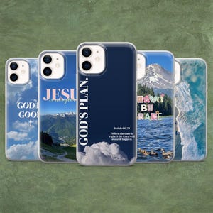 May include: A collection of phone cases with various designs. One case features a navy blue background with the text "GOD'S PLAN." Other cases display mountain landscapes, clouds, and inspirational phrases like "GOD IS GOOD" and "SAVED BY GRACE."