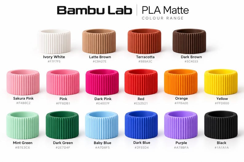 May include: Bambu Lab PLA Matte colour range chart featuring fifteen cylindrical, vertically ribbed 3D printing filament samples in various colors including ivory white, latte brown, terracotta, dark brown, sakura pink, pink, dark pink, red, orange, yellow, mint green, dark green, baby blue, dark blue, purple, and black.