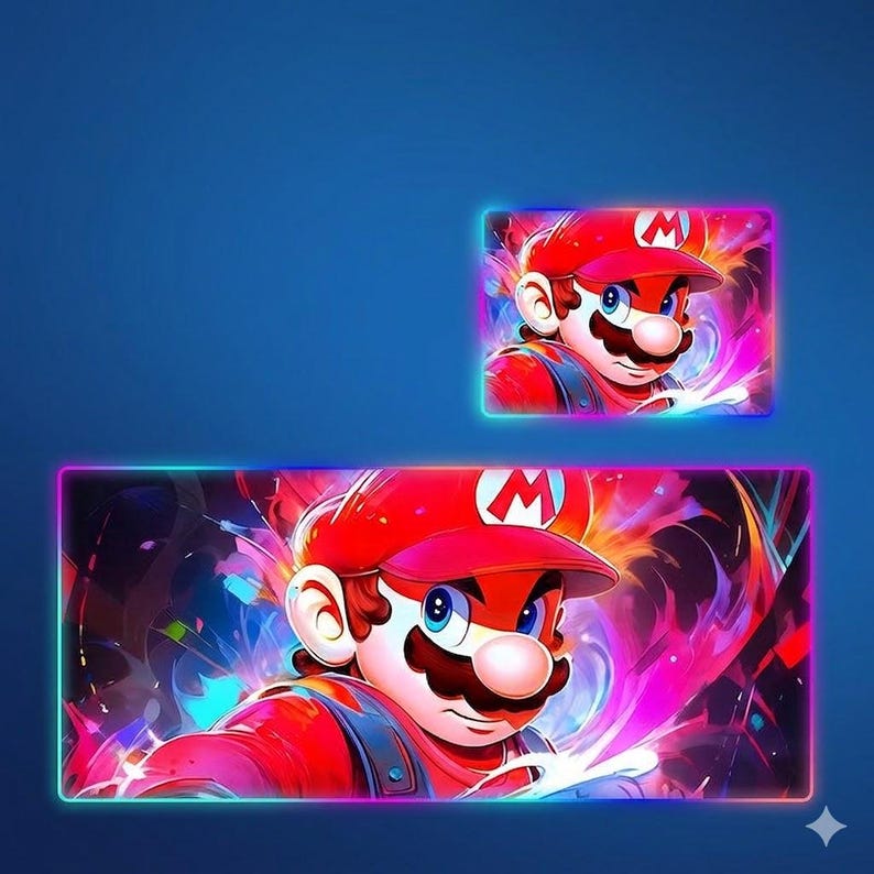 May include: A rectangular desk mat and a smaller matching rectangular mouse pad, both featuring a vibrant, colorful illustration of the character Mario wearing a red cap with an M emblem, set against a dynamic, swirling background of neon colors.