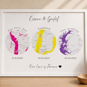 May include: A white framed print with three circular maps, each highlighting a special occasion with a different colour: pink, yellow, and purple. The dates are displayed below each map. The text "Cemre & Gedat" and "Our Love is Forever" are also included.
