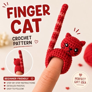 May include: A red crocheted finger cat ring with a long tail, worn on a finger. The image includes the text "FINGER CAT CROCHET PATTERN" and "BEGINNER FRIENDLY". The ring is a cat design with black eyes and whiskers.