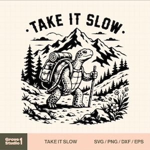 May include: A black and white graphic illustration featuring a turtle hiking with a backpack and a walking stick. The scene includes mountains, pine trees, and flowers. The text "TAKE IT SLOW" is arched at the top. The design is on a grid background.