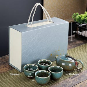 May include: A ceramic tea set with a teal glaze, including a teapot, four small cups, and a gift box. The cups are 5 cm tall and 6 cm wide. The teapot holds 160 ml, and each cup holds 50 ml.