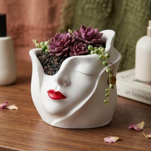 Face-shaped planter, poetic trinket tray in white ceramic, red lip detail