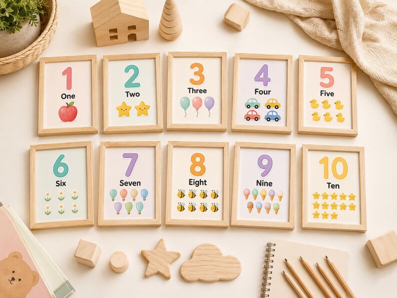 May include: A set of ten framed number cards, each with a number, its word, and corresponding illustrations. The cards feature images of an apple, stars, balloons, cars, ducks, flowers, bees, ice cream cones, and stars.