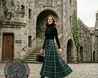 May include: A long, pleated, green and blue tartan kilt skirt featuring a side buckle closure, paired with a black long-sleeved turtleneck sweater and black leather boots, while carrying a small black handbag in front of a stone castle.