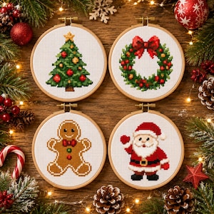 May include: Four circular wooden embroidery hoops containing cross-stitch patterns of a Christmas tree, a festive wreath, a gingerbread person, and Santa Claus. Each design is centered on white fabric, showcasing holiday-themed imagery.