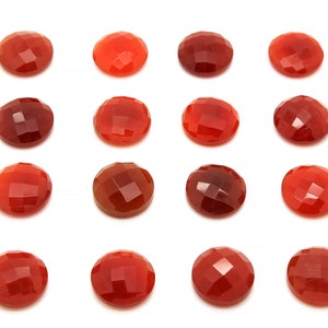 May include: Fifteen round, red carnelian gemstones with a faceted finish. The stones are arranged in a grid pattern on a white background.