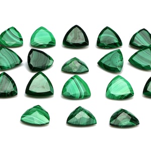 May include: A collection of 18 triangular malachite gemstones, each with a unique green and white pattern. The stones are cut and polished, showcasing the natural beauty of the malachite.