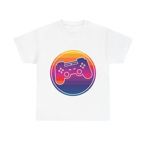 May include: White t-shirt featuring a retro-style graphic of a video game controller inside a colorful circle. The controller is outlined in white, with a gradient background of orange, yellow, purple, and blue. A classic design for gamers.