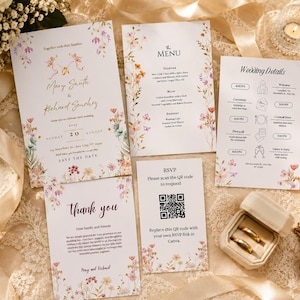 May include: A wedding stationery set featuring a floral invitation, menu, wedding details card, thank you note, and RSVP card with a QR code. The white paper cards are decorated with colourful wildflower illustrations and elegant black and gold text.