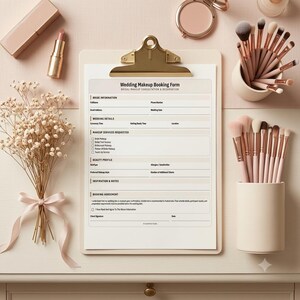 May include: A wedding makeup booking form on a gold clipboard, surrounded by a bouquet of dried baby's breath tied with a ribbon, a lipstick, a compact mirror, and two cylindrical holders filled with various makeup brushes in shades of pink.