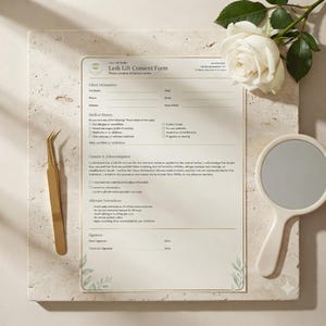 May include: A printed Lash Lift Consent Form document featuring sections for client information, medical history, and aftercare instructions, accompanied by gold-toned tweezers and a round handheld mirror with a cream-colored handle.