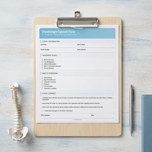 May include: A light wood clipboard holding a white Cryotherapy Consent Form with blue headers. The document includes sections for client information, treatment goals, health screening, and client consent, alongside a silver pen and a spinal model.