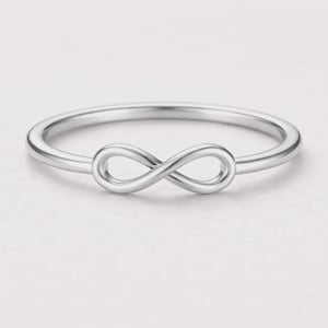 May include: A silver-colored ring featuring an infinity symbol design. The ring has a thin band and a polished finish. The infinity symbol is the focal point, adding a touch of elegance to this jewelry item.